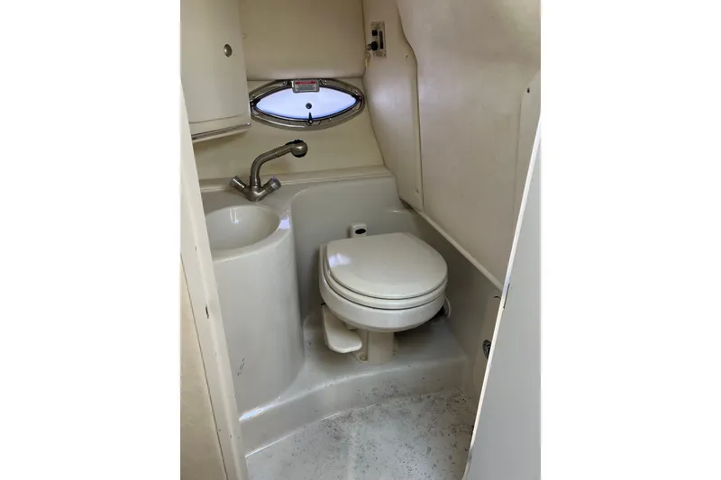 Slide: The Image of Compact bathroom in 2006 Sea Ray 290 Sun Sport boat, featuring toilet and sink. - 27