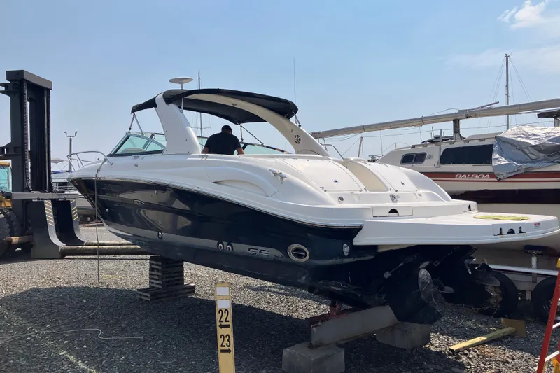 Slide: The Image of 2006 Sea Ray 290 Sun Sport boat on dry dock, side view. - 2