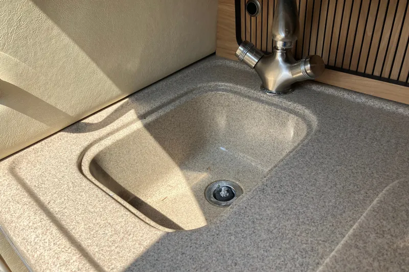 Slide: The Image of Kitchen sink and faucet in 2006 Sea Ray 290 Sun Sport boat. - 20
