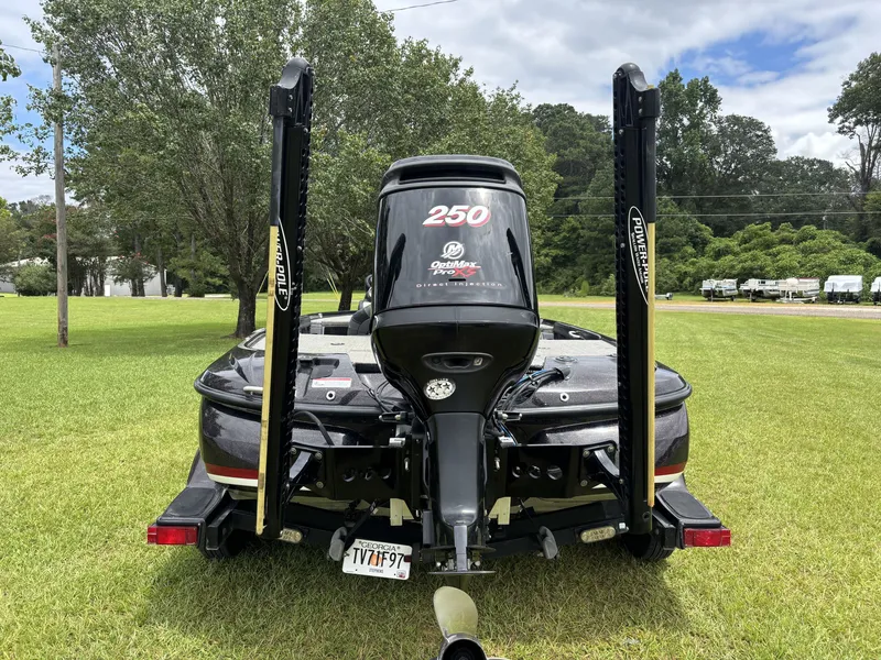 Slide: The Image of A 2011 Nitro Z9 CDC boat with a 250 HP Mercury engine, parked on a grassy area. - 12