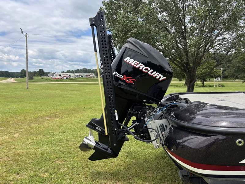 Slide: The Image of A Mercury Pro XS outboard motor is mounted on a 2011 Nitro Z9 CDC boat, situated on a grassy field. - 9