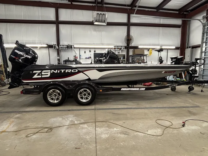 The Image of A 2011 Nitro Z9 CDC boat is on a trailer in a warehouse. - 1
