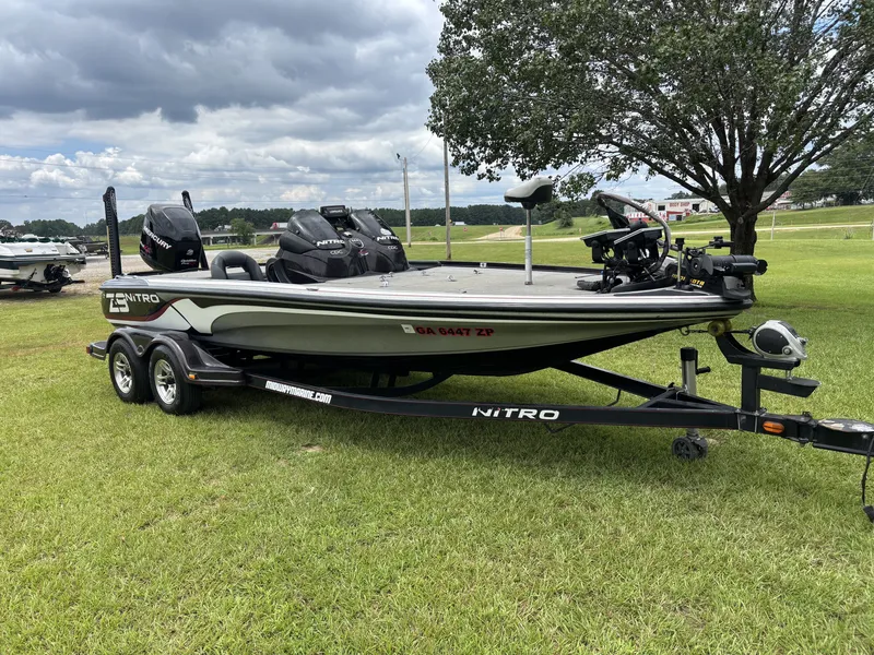 Slide: The Image of A 2011 Nitro Z9 CDC boat on a trailer, parked on a grassy field. - 3