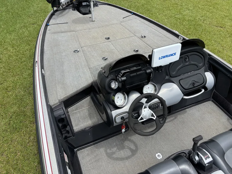 Slide: The Image of The image shows the cockpit of a 2011 Nitro Z9 CDC boat with gray carpeting. - 13