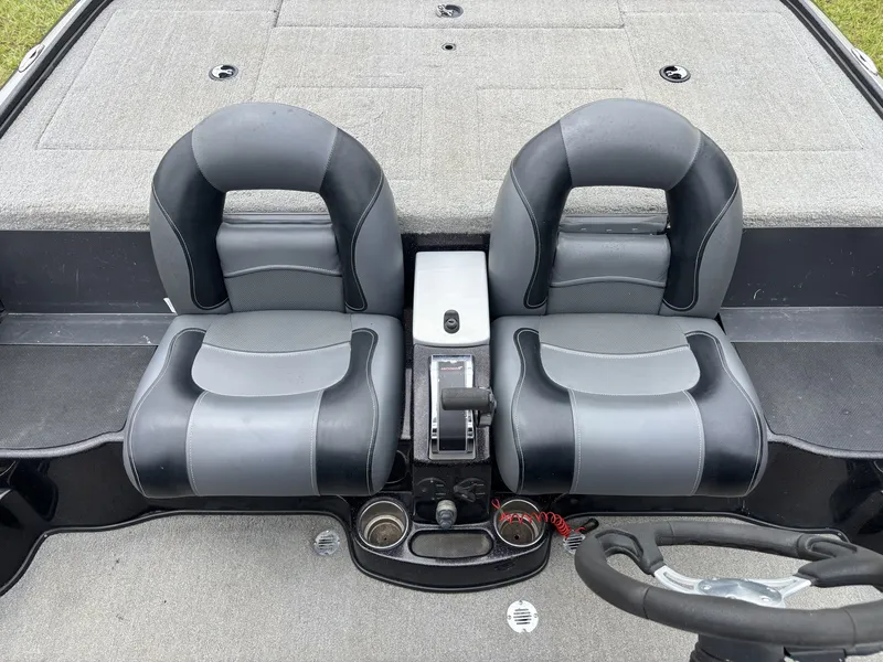Slide: The Image of The image shows two padded seats in a boat, with a control lever in between. - 19