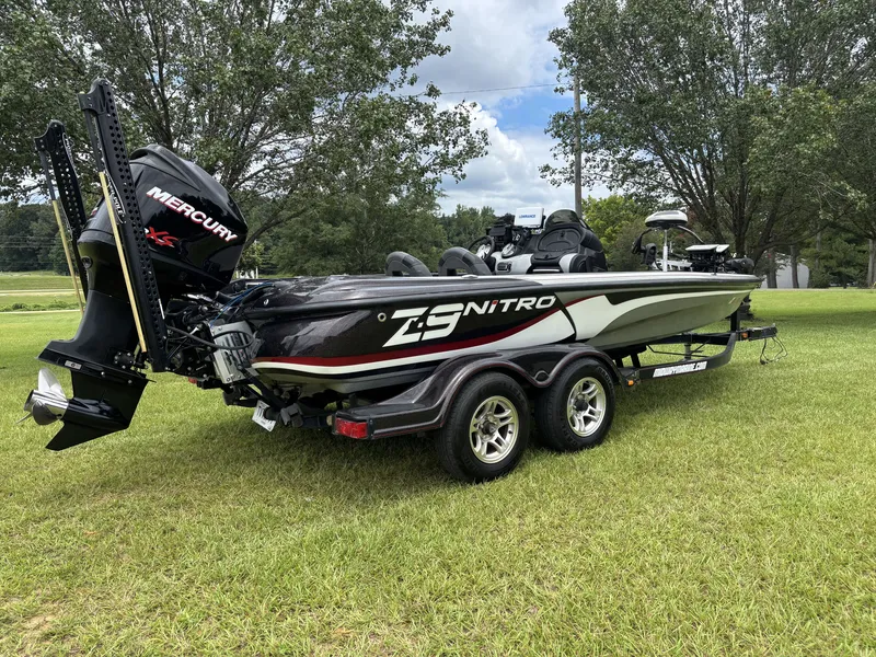 Slide: The Image of A black 2011 Nitro Z9 CDC boat on a trailer, parked on a grassy field. - 6