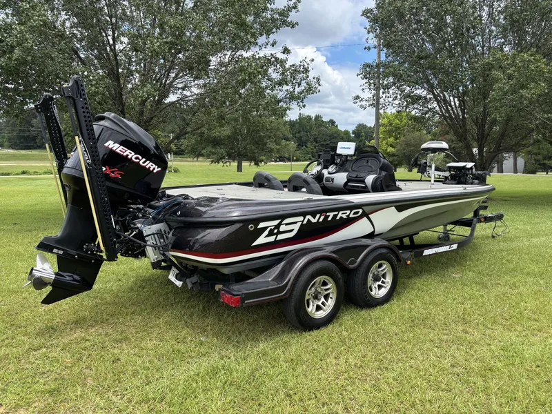 Slide: The Image of A black 2011 Nitro Z9 CDC boat on a trailer, parked on a grassy field. - 8