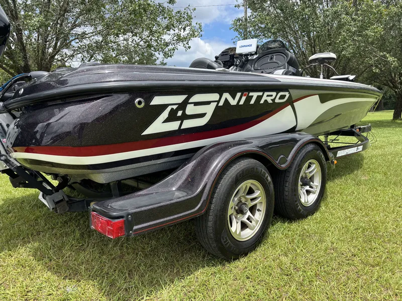Slide: The Image of A black 2011 Nitro Z9 CDC boat on a trailer, parked on grass. - 5