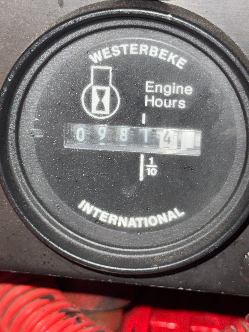Slide: The Image of Close-up of a Westerbeke engine gauge showing 9814.1 hours. - 26