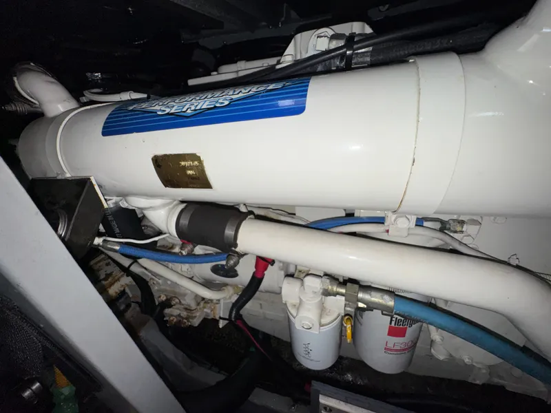 Slide: The Image of Close-up of an engine room with a white engine and blue hoses. - 23