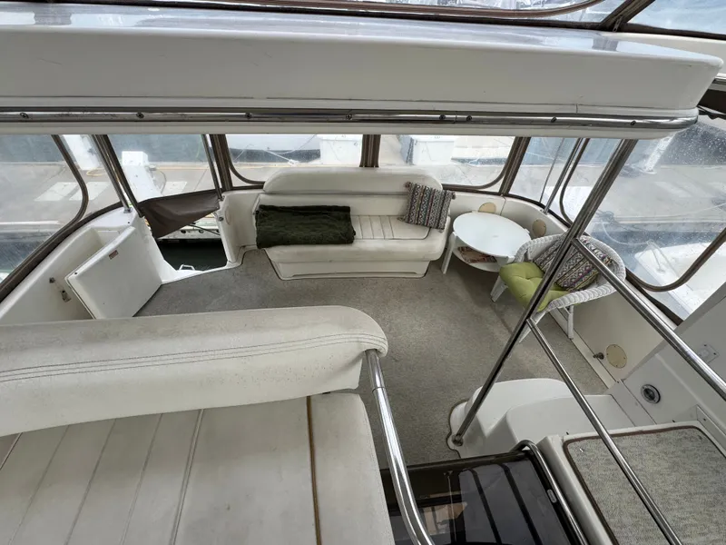 Slide: The Image of The 2000 Sea Ray 420 Aft Cabin features a spacious interior with seating and a table. - 5