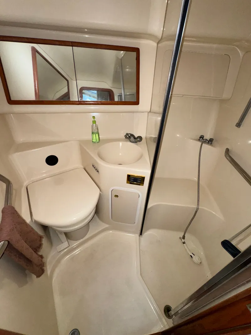 Slide: The Image of The image shows a yacht bathroom with a toilet, sink, and shower. - 20
