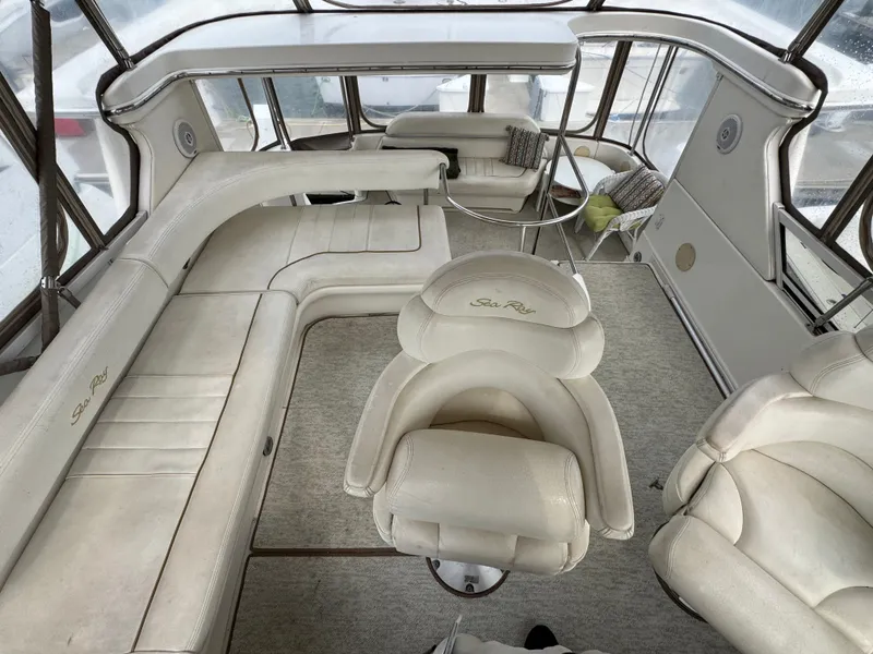 Slide: The Image of The image shows the cockpit of a 2000 Sea Ray 420 Aft Cabin with white leather seating. - 4