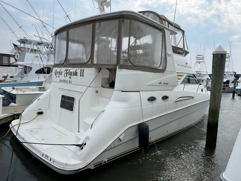 The Image of A 2000 Sea Ray 420 Aft Cabin docked in a marina. It features a spacious aft deck. - 0