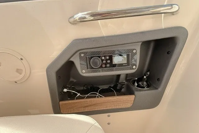 Slide: The Image of Control panel of a 2015 Grady-White Freedom 285 boat with audio system and storage. - 13