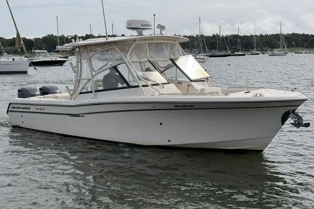 The Image of 2015 Grady-White Freedom 285 boat on water, surrounded by other vessels. - 0