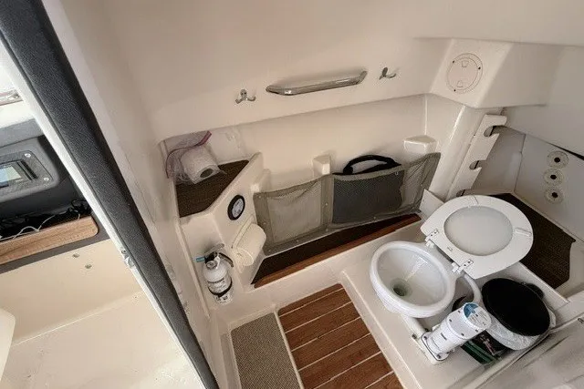 Slide: The Image of 2015 Grady-White Freedom 285 boat interior with compact bathroom amenities. - 15