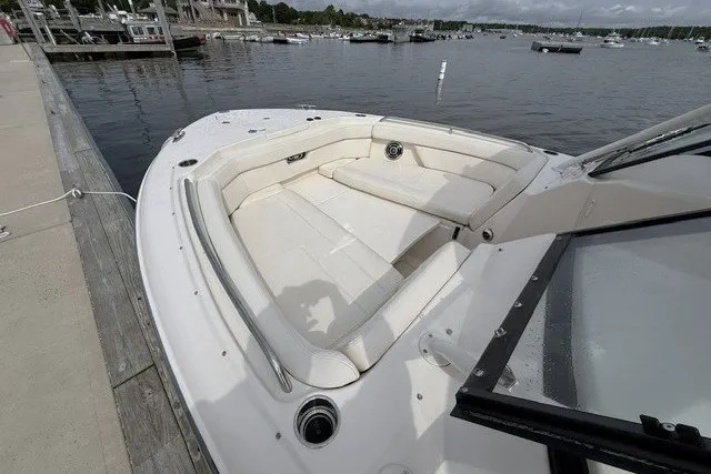 Slide: The Image of 2015 Grady-White Freedom 285 boat with spacious seating, docked by a serene waterfront. - 7