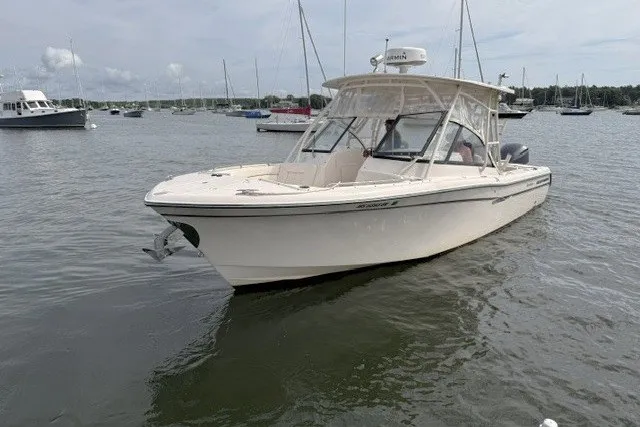Slide: The Image of 2015 Grady-White Freedom 285 boat on calm water with other boats in the background. - 3