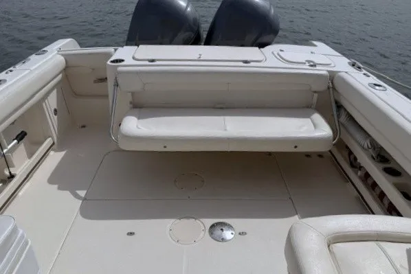 Slide: The Image of 2015 Grady-White Freedom 285 boat interior with seating and dual engines. - 12