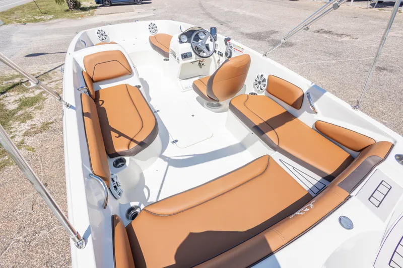 Slide: The Image of 2021 Stingray 182 SC boat interior with tan seating and modern dashboard. - 22