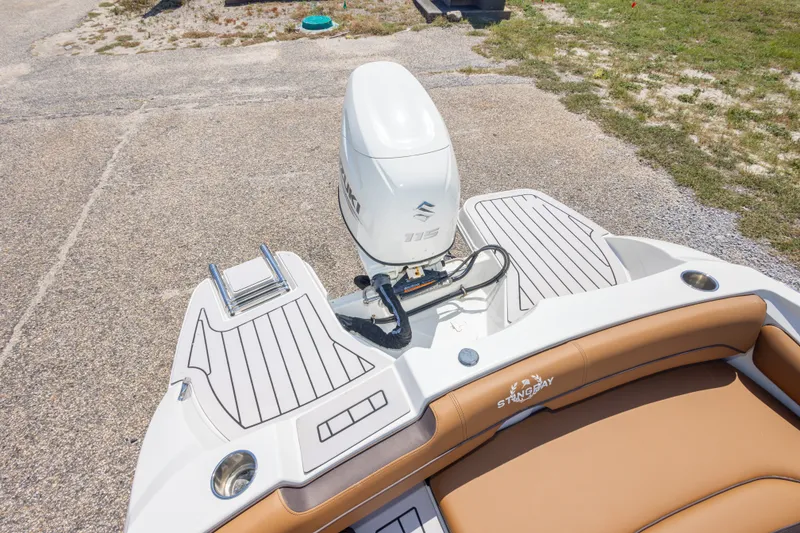 Slide: The Image of 2021 Stingray 182 SC boat with Suzuki outboard motor and tan seating. - 34