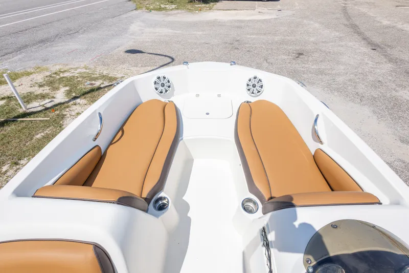 Slide: The Image of 2021 Stingray 182 SC boat interior with tan seating and speakers. - 27