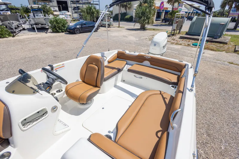 Slide: The Image of 2021 Stingray 182 SC boat with tan seating, parked outdoors. - 31