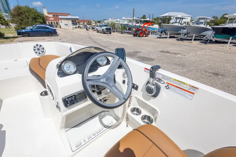 Slide: The Image of 2021 Stingray 182 SC boat interior with steering wheel and dashboard controls. - 26