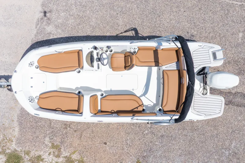 Slide: The Image of 2021 Stingray 182 SC boat, aerial view, featuring tan seating and sleek design. - 6