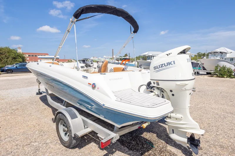 Slide: The Image of 2021 Stingray 182 SC boat with Suzuki outboard motor on a trailer. - 13