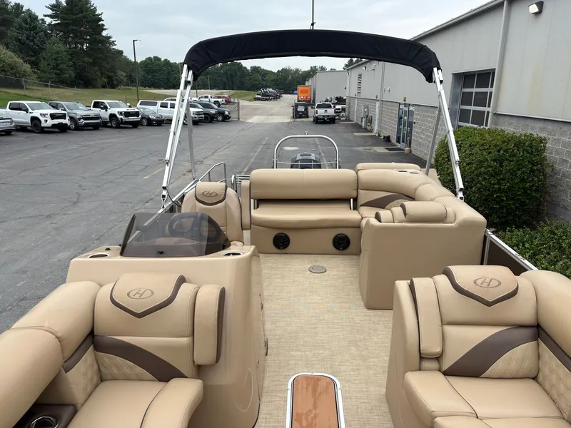 Slide: The Image of The image shows the interior of a 2019 Harris Sunliner 230 with beige seating and a black sunshade. - 18