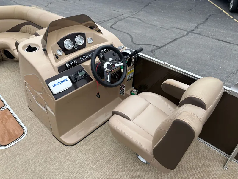 Slide: The Image of The image shows the cockpit of a 2019 Harris Sunliner 230 with beige steering and instruments. - 12