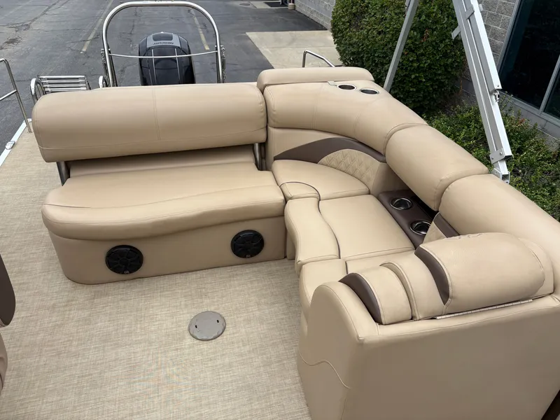 Slide: The Image of The image shows the beige seating of a 2019 Harris Sunliner 230 with built-in speakers. - 11