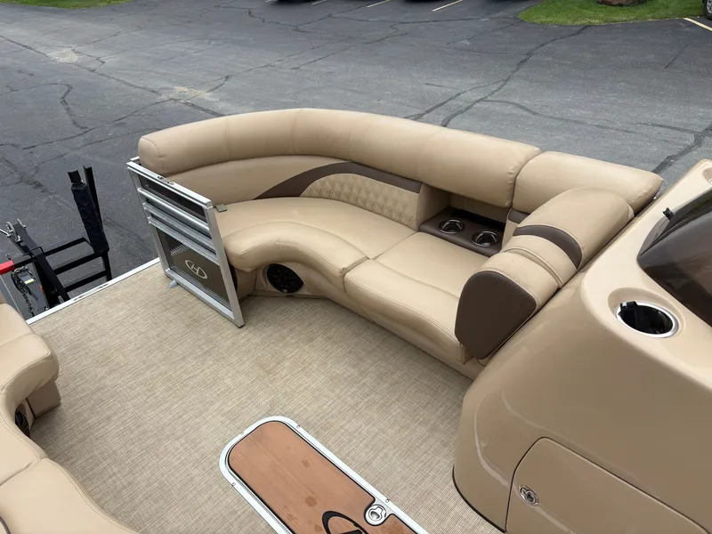 Slide: The Image of The image shows the beige interior of a 2019 Harris Sunliner 230 pontoon boat. - 16