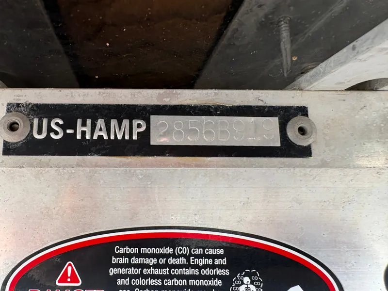 Slide: The Image of Close-up of a boat part with serial number and carbon monoxide warning label. - 19