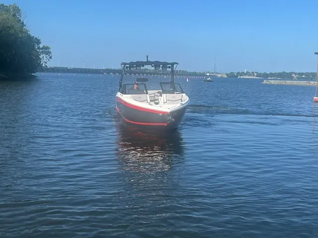 Slide: The Image of A 2022 Cobalt R8 Surf boat cruising on calm waters under a clear sky. - 3