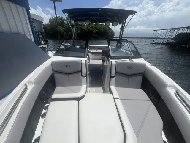 Slide: The Image of The image shows the cockpit of a 2022 Cobalt R8 Surf boat with gray upholstery. - 18