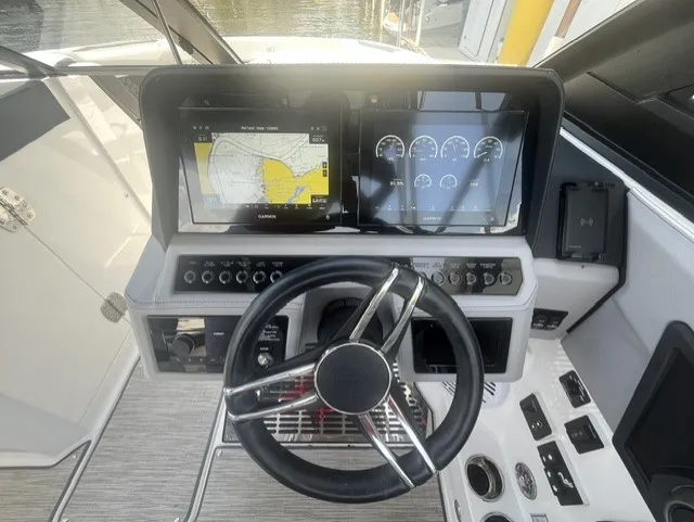 Slide: The Image of The image shows the helm of a 2022 Cobalt R8 Surf boat with modern instruments. - 17