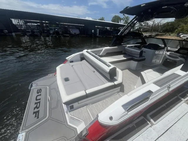 Slide: The Image of The image shows a 2022 Cobalt R8 Surf boat with gray upholstery and an open deck. - 6
