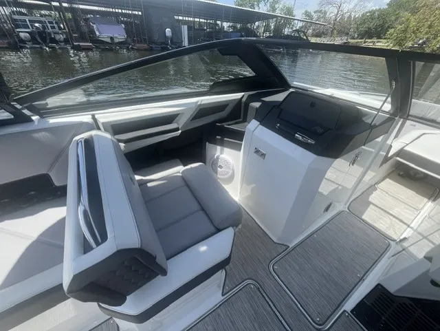 Slide: The Image of The image shows the cockpit of a 2022 Cobalt R8 Surf boat with modern seating and controls. - 12
