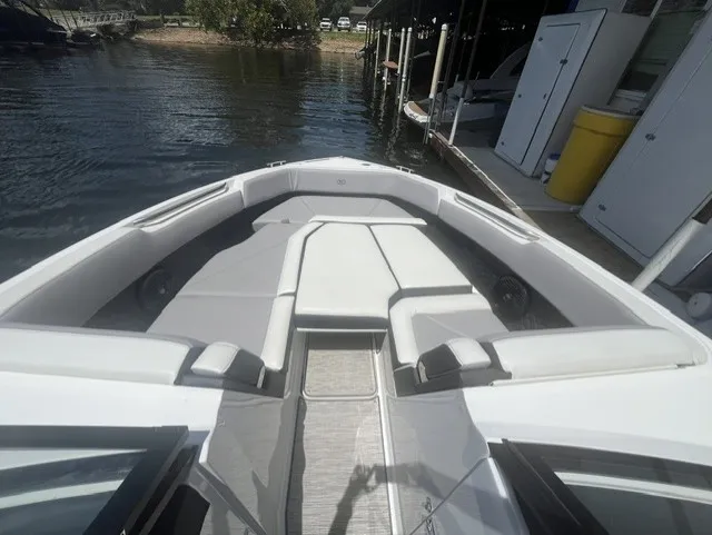 Slide: The Image of The image shows the bow of a 2022 Cobalt R8 Surf boat with gray upholstery. - 19