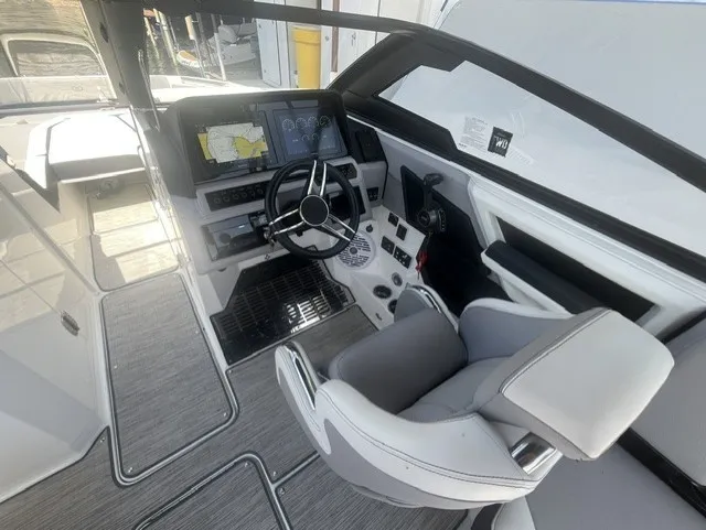 Slide: The Image of The image shows the cockpit of a 2022 Cobalt R8 Surf boat with modern instruments. - 16
