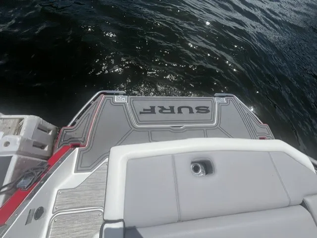 Slide: The Image of The image shows the stern of a 2022 Cobalt R8 Surf boat on the water. - 5