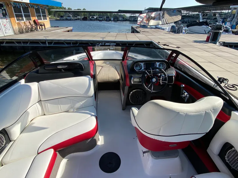 Slide: The Image of The image shows the cockpit of a 2012 Malibu 247 LSV with white and red seating. - 6