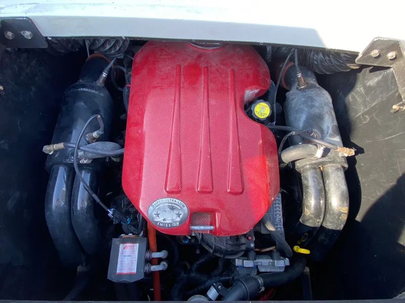 Slide: The Image of The engine compartment of a 2012 Malibu 247 LSV features a red engine block with black components. - 8