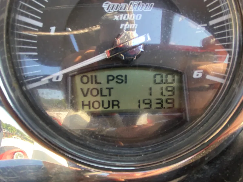 Slide: The Image of Close-up of a Malibu 247 LSV dashboard showing oil, volt, and hour gauges. - 9