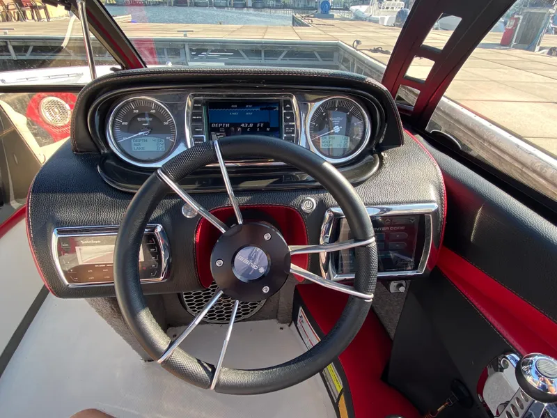 Slide: The Image of The image shows the cockpit of a 2012 Malibu 247 LSV with a modern steering wheel and instruments. - 10