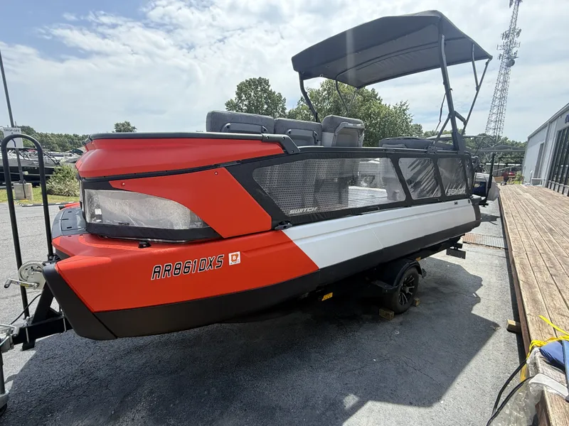 Slide: The Image of A 2023 Sea-Doo Switch Cruise with a red and white hull sits on a trailer. - 3