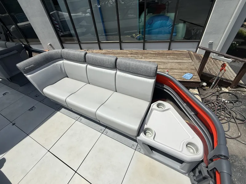 Slide: The Image of The image shows a gray seating area on a 2023 Sea-Doo Switch Cruise with a small table. - 9